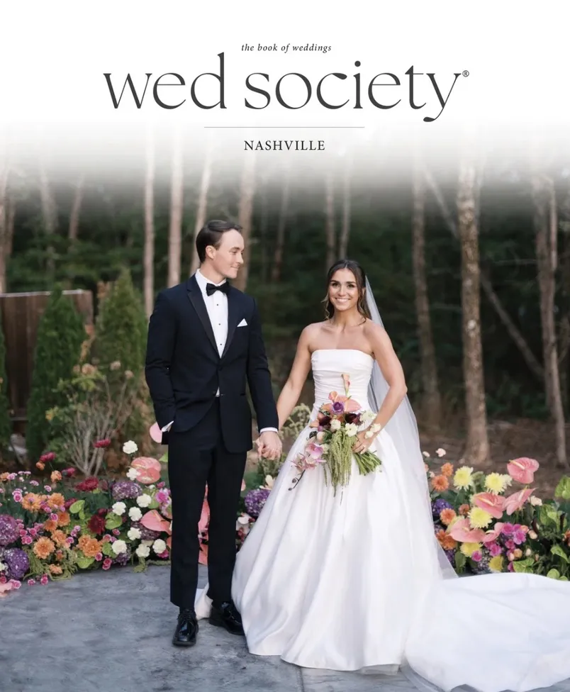 Wed Society Nashville — The Book of Weddings cover featuring a bride and groom surrounded by lush floral arrangements