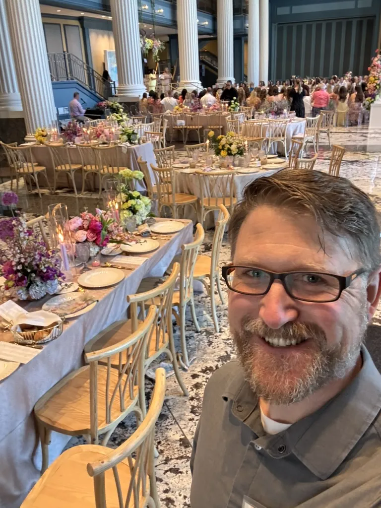 Inside the Fisher Center ballroom at the Wed Society book release — elegant table settings with floral centerpieces and candlelight