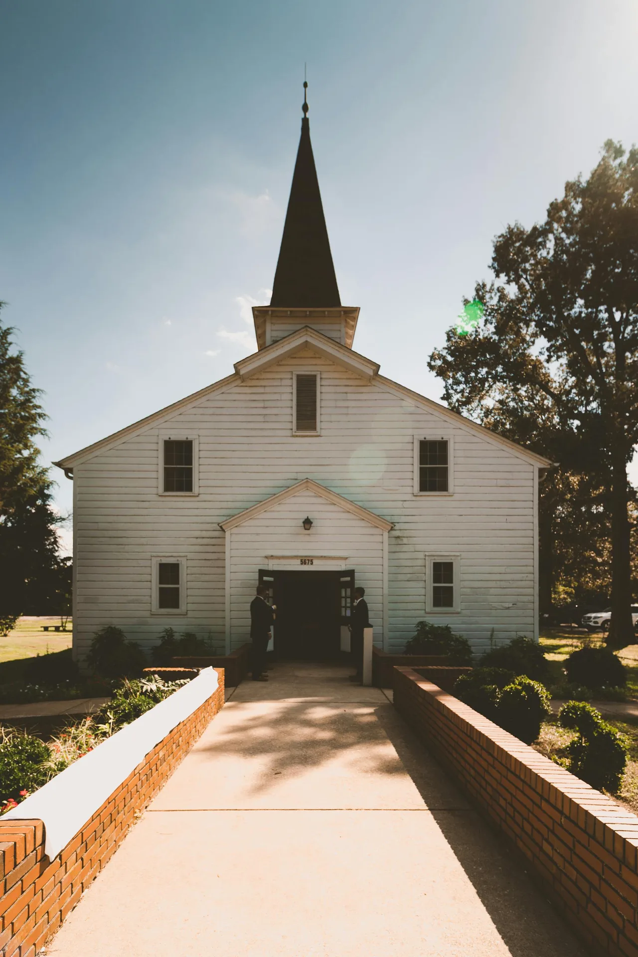Couple standing outside a white church on their wedding day in Clarksville Tennessee