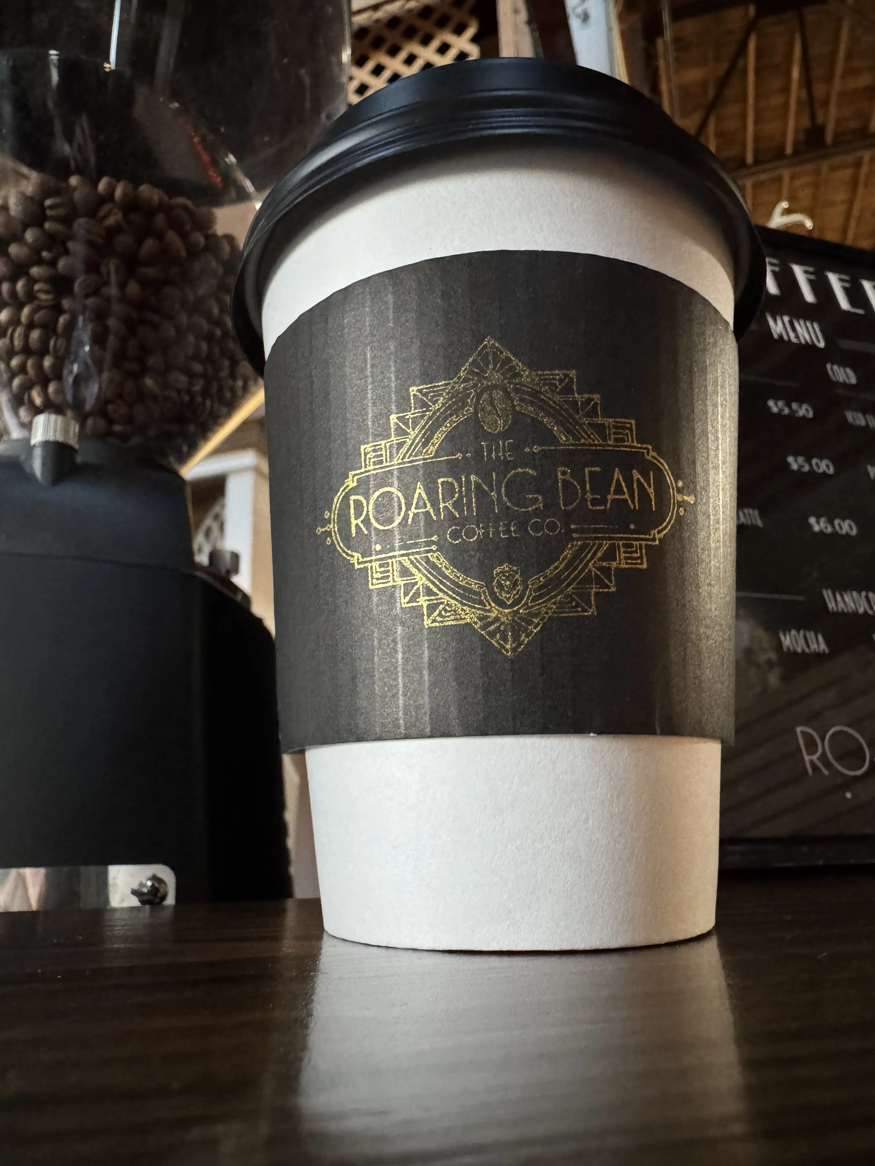 The Roaring Bean branded coffee cup — corporate espresso bar catering Clarksville TN