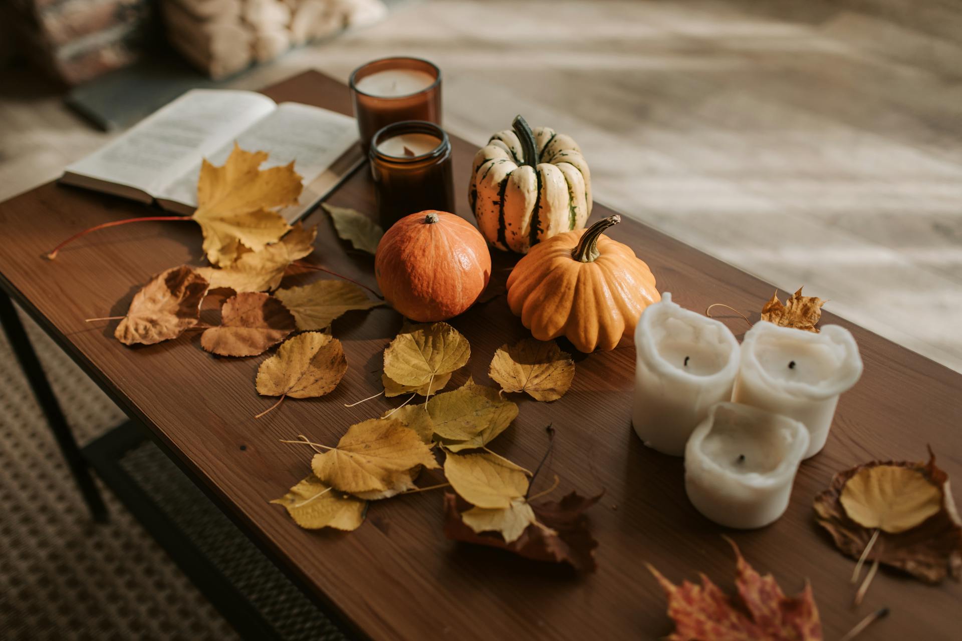 Autumn pumpkins, golden leaves, and candles on a rustic wood table — fall wedding coffee bar aesthetic in Tennessee